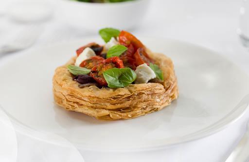 Caramelised onion tart with anchovy, roasted cherry tomatoes, goat's feta and basil